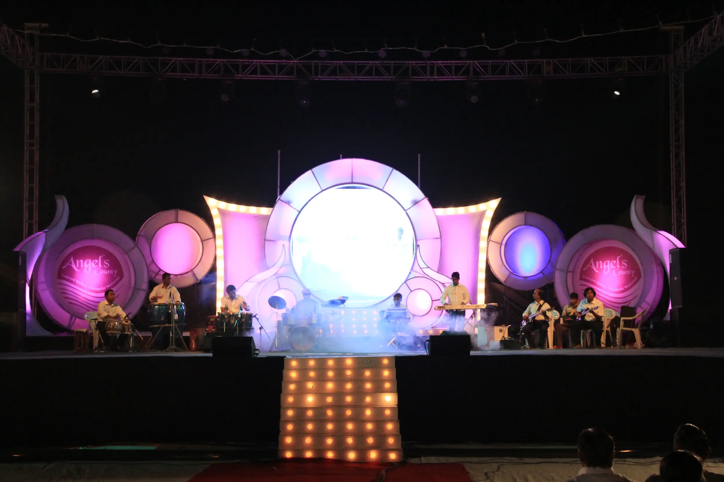 Festival Celebrations with people dancing on stage and colorful lighting